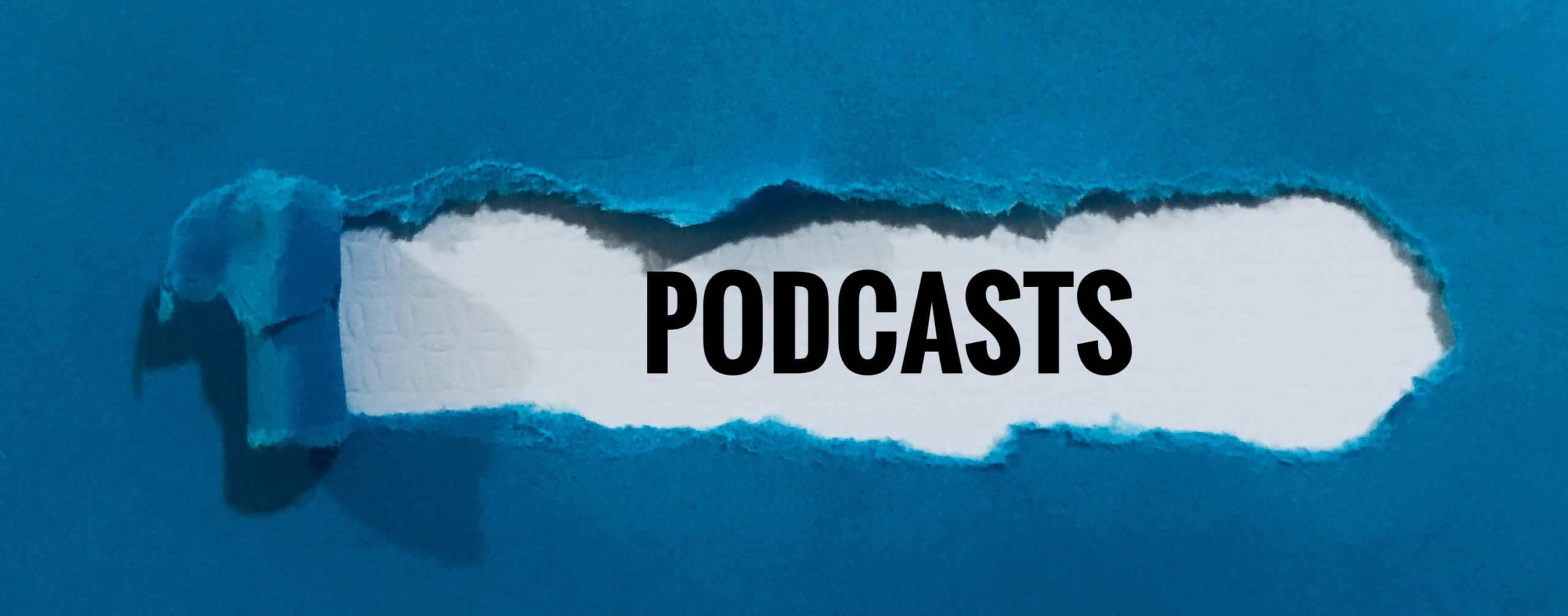 Blue paper torn back to reveal the word podcasts
