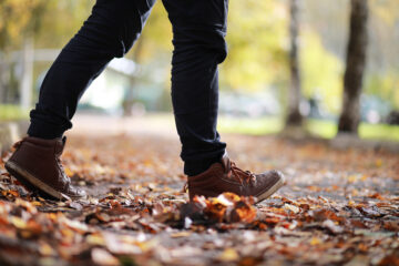 Autumn,Park,Man,Walking,Along,A,Path,Foliage