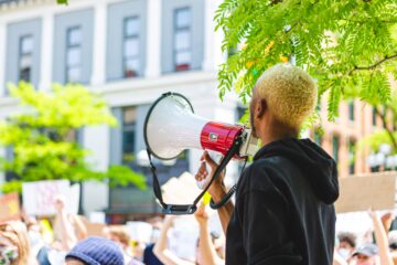 person-of-color-holding-a-megaphone-at-a-peaceful-2025-01-09-01-54-43-utc